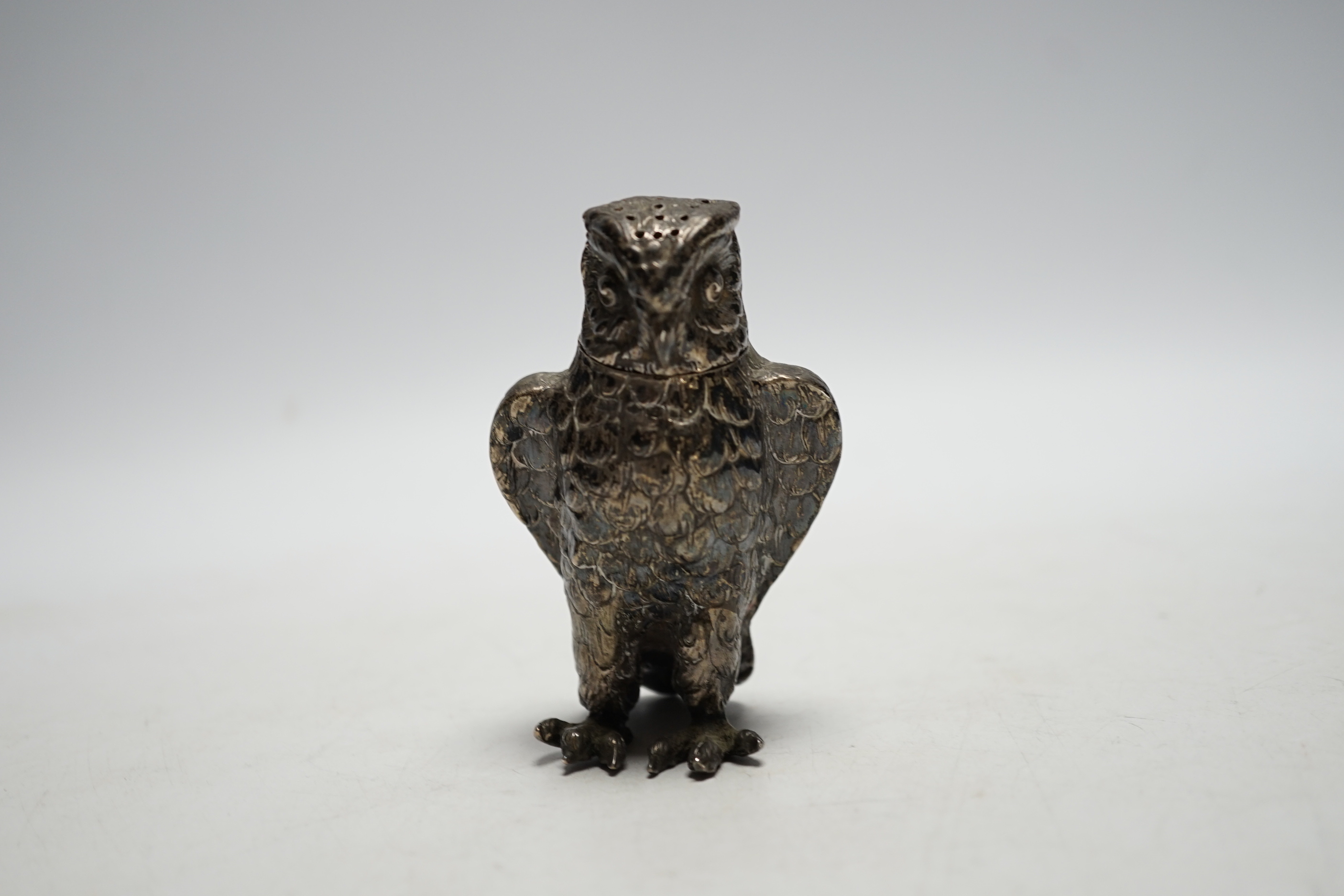 A late 19th/early 20th century novelty silver pepperette, modelled as an owl, import marks for Berthold Muller, London, no date letter, 93mm.